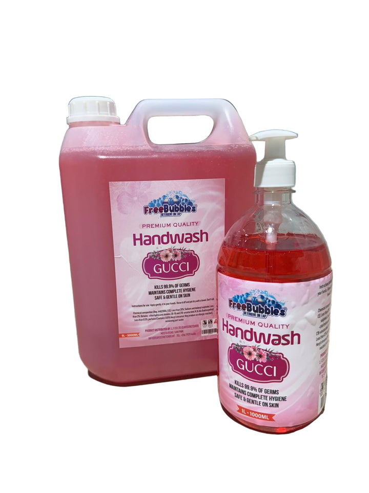 Two bottles of FreeBubbles handwash with Gucci branding on a concrete surface.