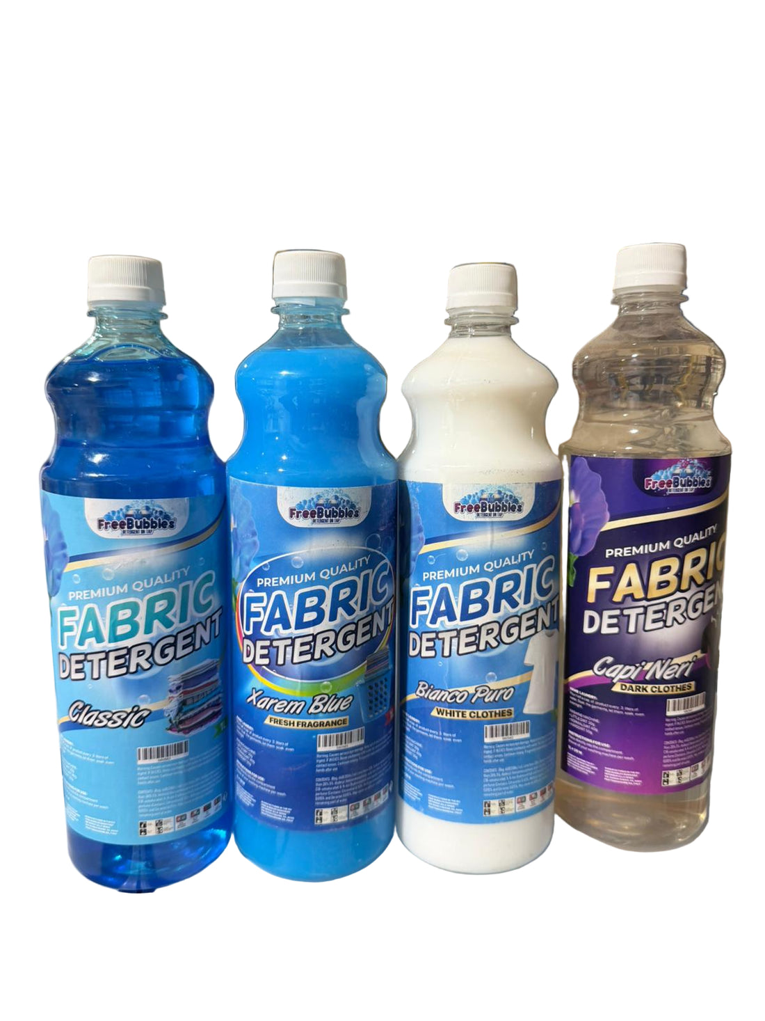 Four bottles of fabric detergent on a counter with a blurred background
